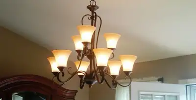 Classic ceiling chandelier installation with warm lighting in Long Beach, CA