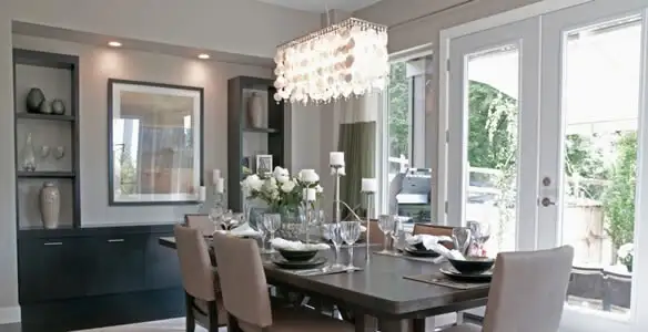Elegant dining room chandelier installation above table in Long Beach, CA