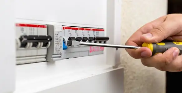 electrical panel upgrade service showing technician adjusting circuit breakers during system upgrade in Long Beach, CA