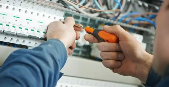 electrical service showing licensed electrician performing electrical panel maintenance and adjustments in Long Beach, CA