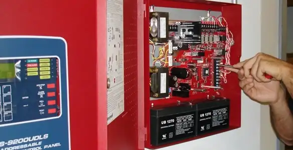 fire alarm installation service showing technician configuring fire alarm control panel in Long Beach, CA