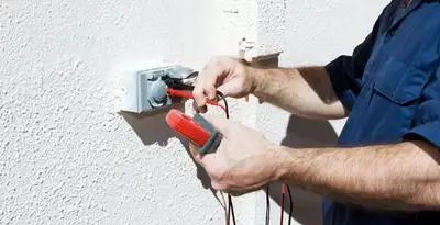 Electrician performing home electrical outlet and wiring inspection in Long Beach, CA