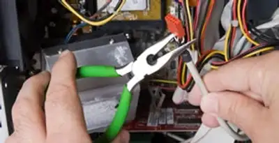 Licensed electrical contractor performing electrical repair with tools in Wilmington, CA