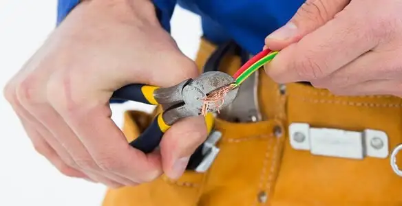 licensed electrician securing electrical wiring with professional tools during service work in Long Beach, CA