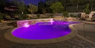 pool light installation and repair services illuminating a residential swimming pool in Long Beach, CA
