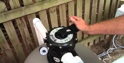 pool pumps service showing professional adjustment of pool pump control system in Long Beach, CA